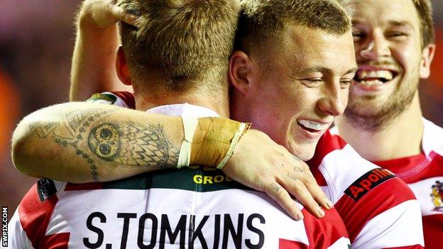 Josh Charnley and Sam Tomkins celebrate