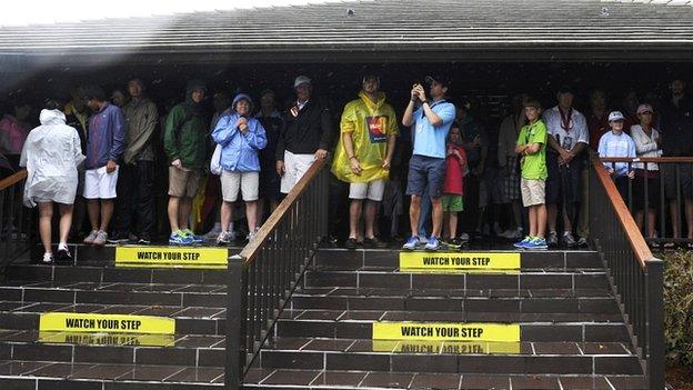 Spectators shelter at the Arnold Palmer Invitational