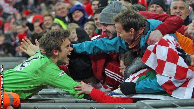 Wrexham goalkeeper Chris Maxwell celebrates with fans