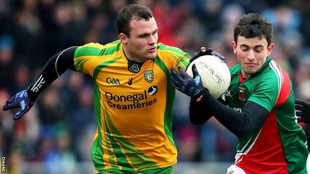 Neil McGee battles with Mayo's Jason Doherty in Sunday's Football League clash