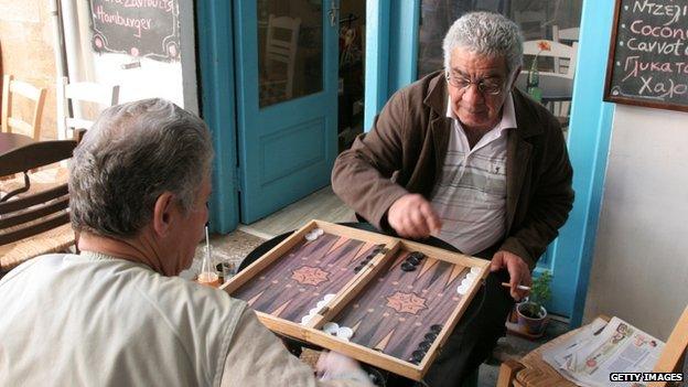 Cypriots play backgammon outside a cafe in the old city of Nicosia