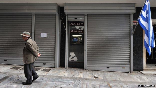 A man in Cyprus outside a closed bank