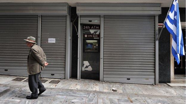 A man in Cyprus outside a closed bank