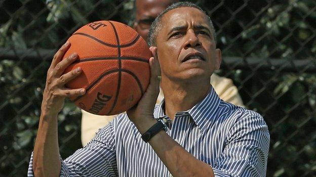 US President Barack Obama holding basketball