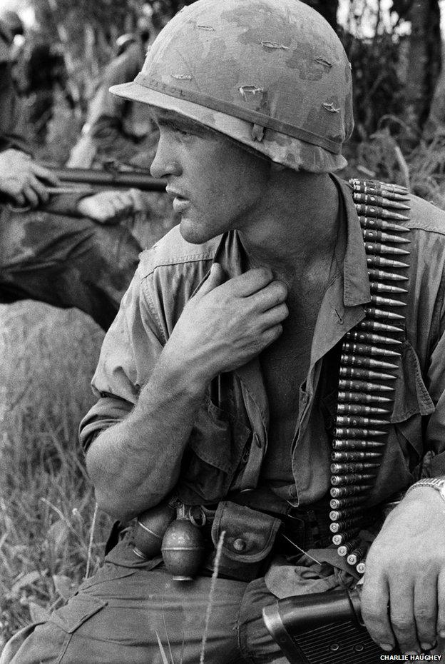 An M60 operator pauses for a moment under the heavy load of machine gun ammunition