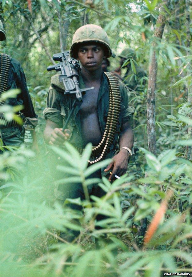 An alert, young M60 machine gun operator in the jungle