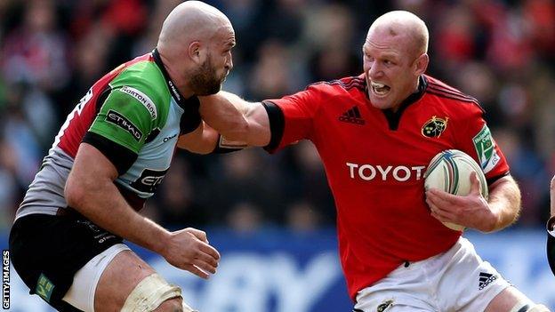 Harlequins second row George Robson looks to tackle Munster counterpart Paul O'Connell