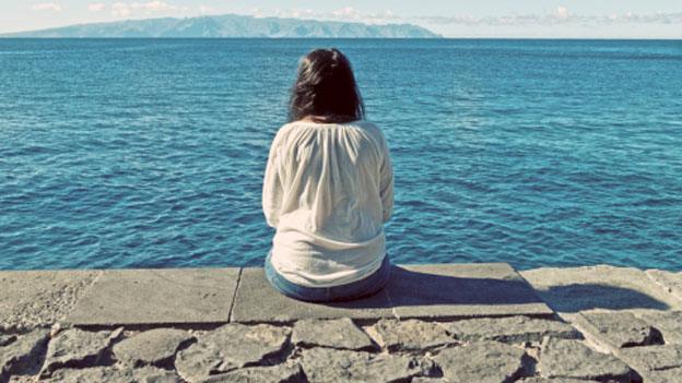 Woman looking out to sea