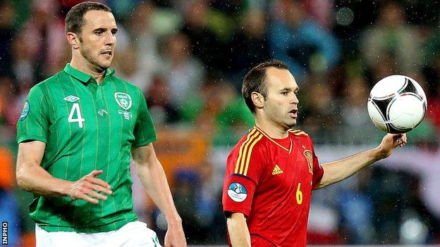 John O'Shea battles with Andres Iniesta during last year's game at Euro 2012