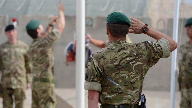 Marines lower the flag at their base in Afghanistan for the final time