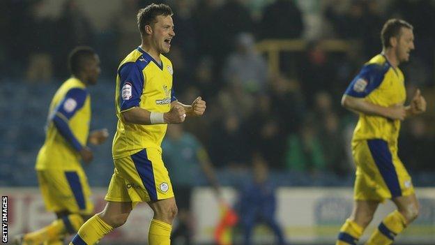 Chris Maguire celebrates (second left)