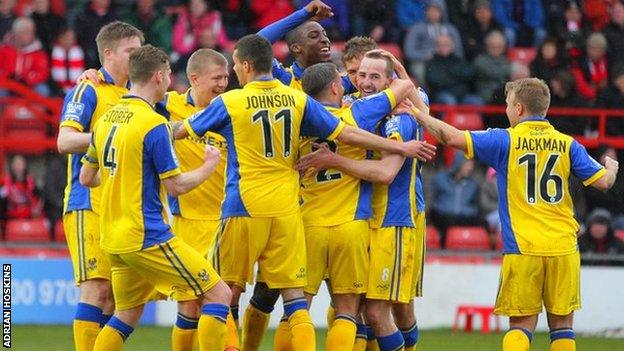 Kidderminster Harriers players celebrate James Vincent's opening goal at the Racecourse Ground