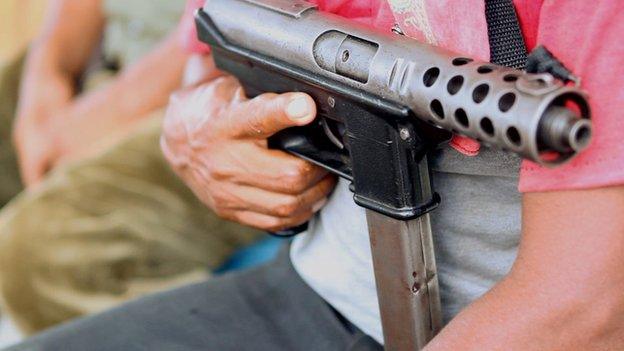 A gun held by a member of Ayulta's self-defence force