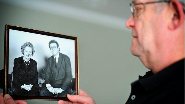 Bill Sharp holds a photograph of himself with Margaret Thatcher