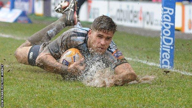 Gavin Evans sends up spray at the Arms Park as he scores a try for the Cardiff Blues.