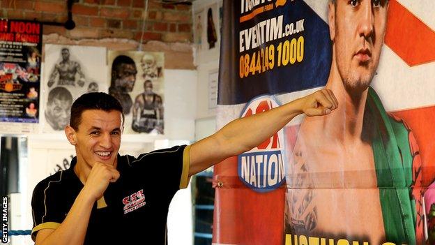 Robin Krasniqi spars with a poster of Nathan Cleverly.