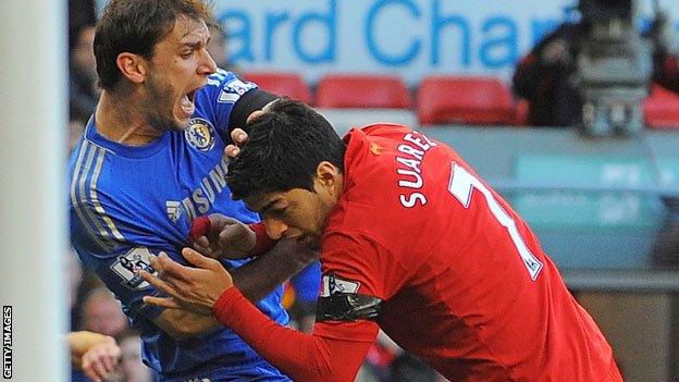 Luis Suarez tangles with Branislav Ivanovic