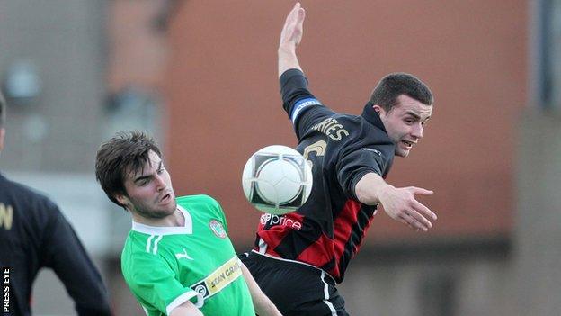 Colin Coates (right) battles with Cliftonville's Jonathan McMurray at Seaview