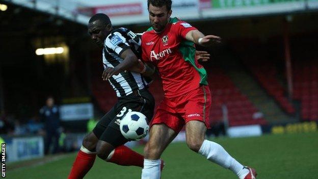 Grimsby's Cleveland Taylor and Newport Andy Sandell battle for the ball