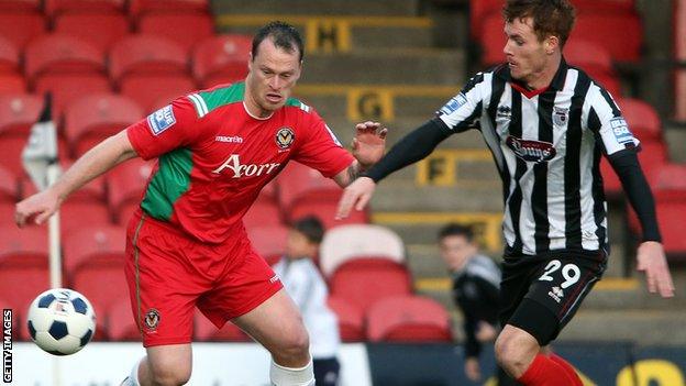 Newport's Mike Flynn in action against Grimsby's Tom Naylor