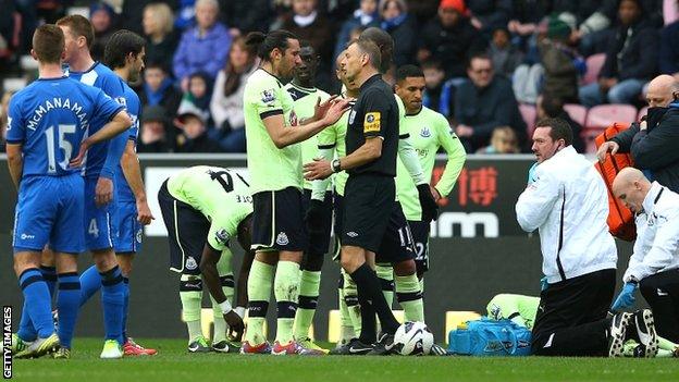 Newcastle players discuss Callum McManaman's challenge with referee Mark Halsey