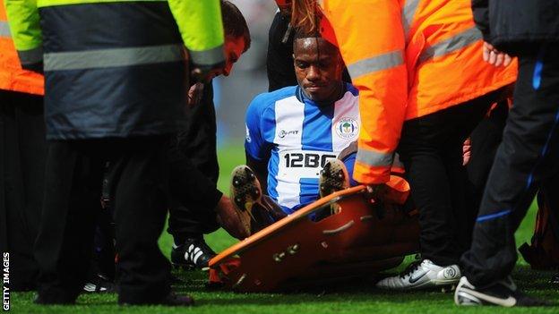 Wigan defender Maynor Figueroa is taken off on a stretcher