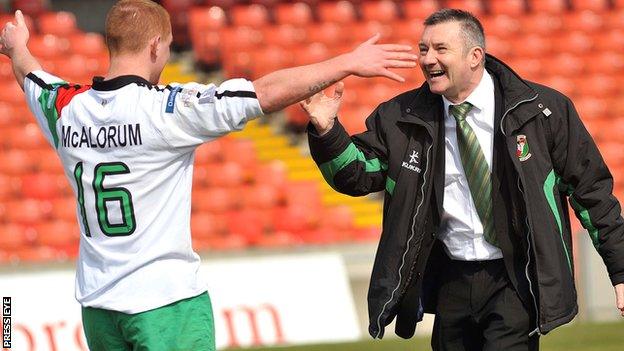 Glens midfielder Stephen McAlorum celebrates the semi-final win over Portadown with manager Eddie Patterson