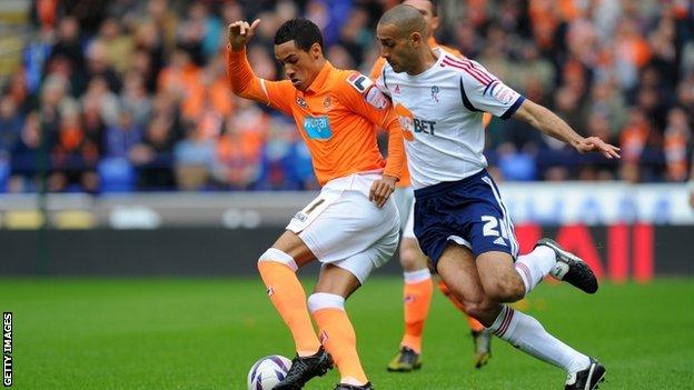 Blackpool's Tom Ince battles for possession