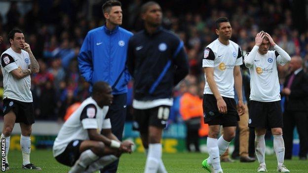 Peterborough's players look dejected after their relegation is confirmed