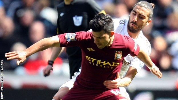 Manchester City's Sergio Aguero clashes with Swansea defender Chico Flores during the Premier League clash at the Liberty Stadium.