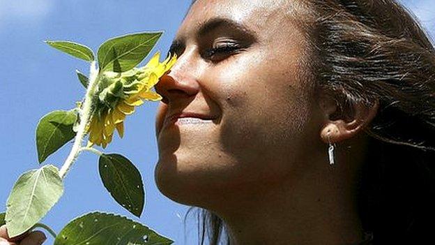 Woman smells flower