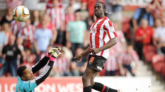 Clayton Donaldson chips Swindon keeper Wes Foderingham for Brentford's third goal at Griffin Park