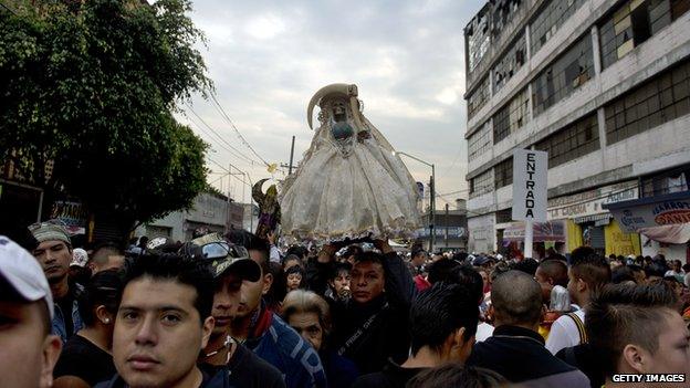 A statue of Santa Muerte is carried through the streets of Mexico City on 1 November 2012