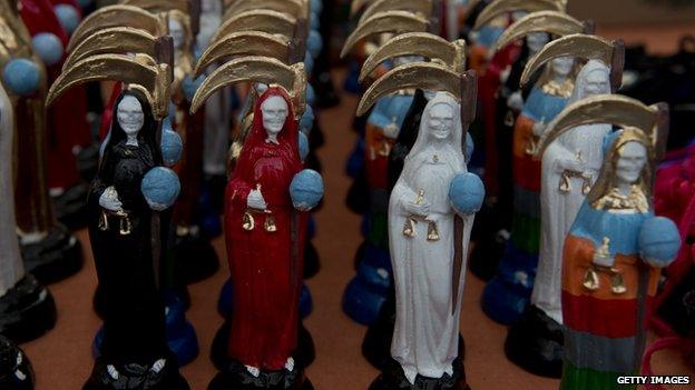 Statues of Santa Muerte are lined up for sale in Mexico City on 1 November 2012