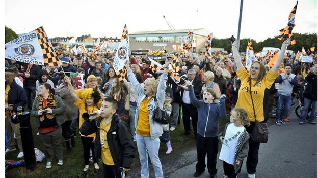 Fans celebrate as Newport County's team arrive back at Rodney Parade