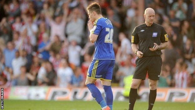 Miles Storey reacts to missing a penalty against Brentford