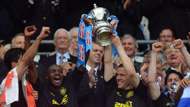 Wigan Athletic players lift the FA Cup.