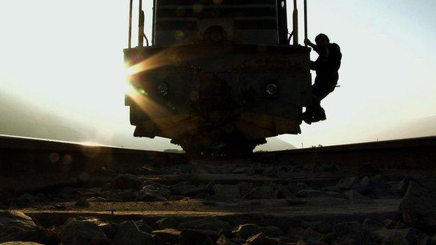 A man holds on to a train on the Arica-La Paz railway (file photo)