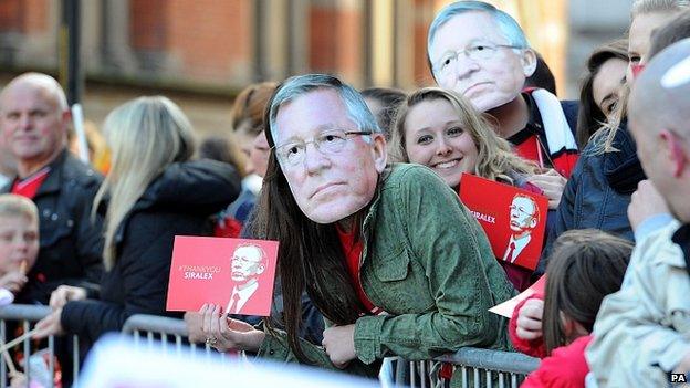 Fans in Sir Alex Ferguson masks in Albert Square