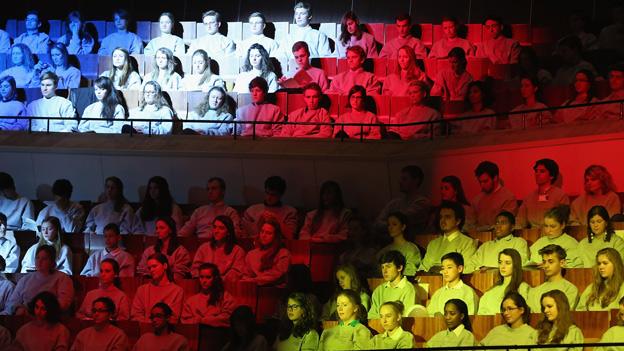 Children bathed in lights of French and German flags