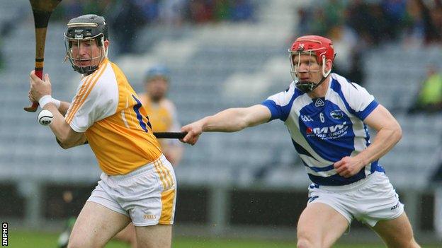 Antrim's Eddie McCloskey in action against Matthew Whelan of Laois