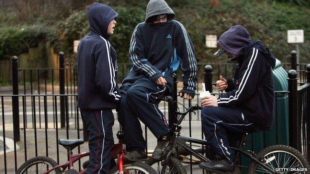 Young people on bikes at a playground