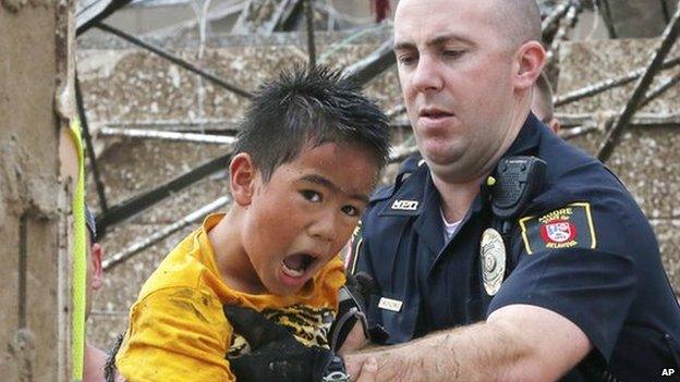 A boy is pulled from the wreckage of Plaza Towers Elementary School in Moore