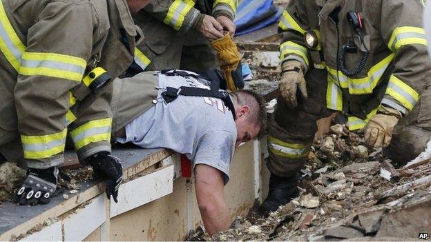 Rescue workers dig through the rubble of a collapsed wall at the Plaza Towers Elementary School in Moore