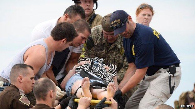 Rescue workers carry a woman to safety from the Moore Medical Center