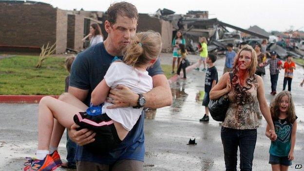 Teachers carry children away from Briarwood Elementary school in south Oklahoma City