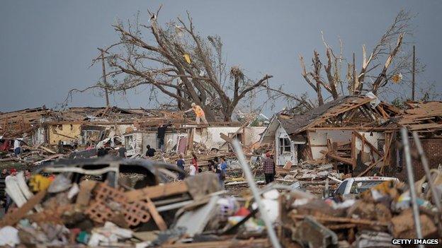 People assess the damage to their homes