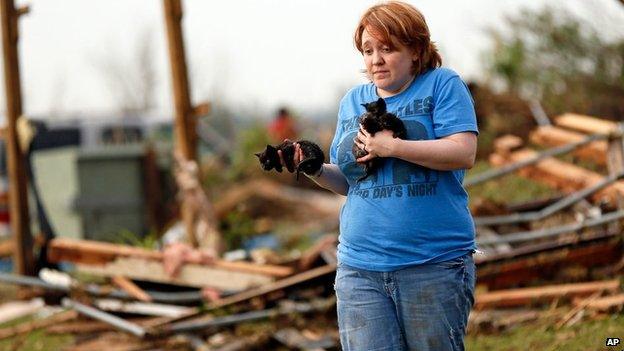 Rachel Hilton holds stray kittens found in the debris