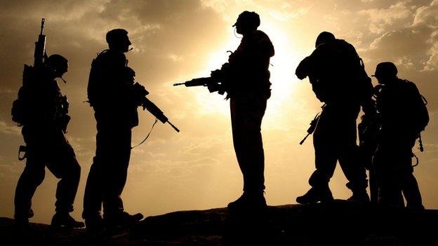 British soldiers from 21 Air Assault Battery Royal Artillery, are silhouetted against the sky at the fortress Qala-e-Bost in Lashkar Gah, Helmand province