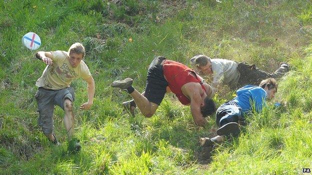 Cheese-rolling racers tumble down Cooper's Hill